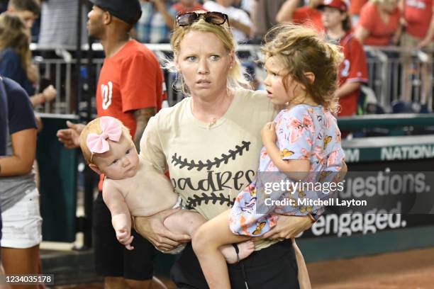 Fans run on the field for cover after what was believed to be shots were heard during a baseball game between the San Diego Padres and the Washington...