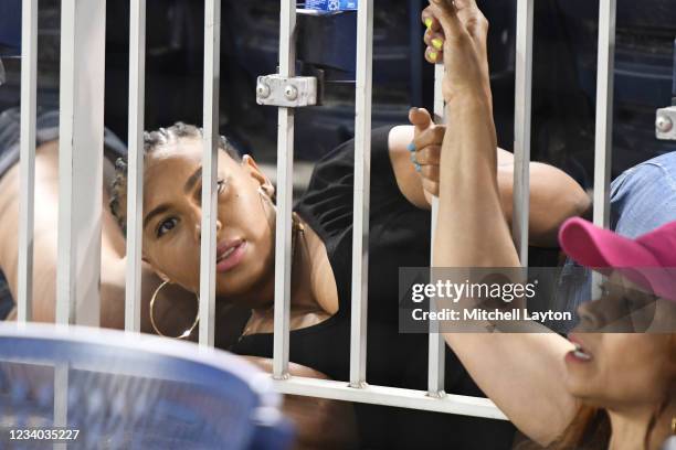 Fan hides under a seat after shots are heard from a shooting outside the stadium which sent players and fans seeking shelter during a baseball game...