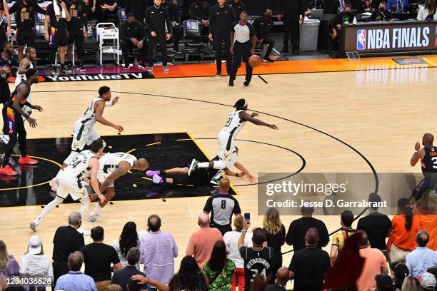 Jrue Holiday of the Milwaukee Bucks steals the ball from Devin Booker of the Phoenix Suns during Game Five of the 2021 NBA Finals on July 17, 2021 at...