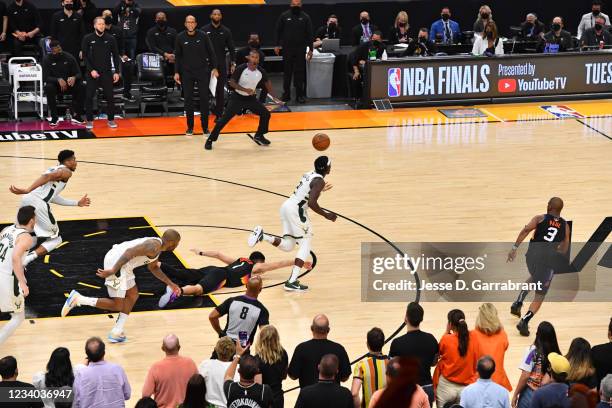 Jrue Holiday of the Milwaukee Bucks steals the ball from Devin Booker of the Phoenix Suns during Game Five of the 2021 NBA Finals on July 17, 2021 at...