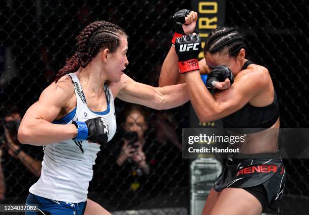 In this handout photo provided by UFC, Miesha Tate punches Marion Reneau in their bantamweight bout during the UFC Fight Night event at UFC APEX on...