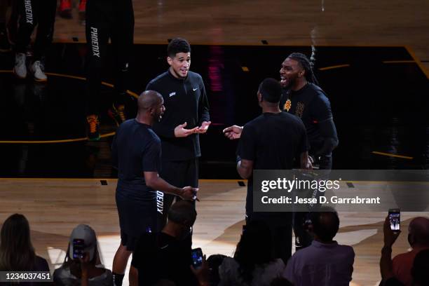 Chris Paul of the Phoenix Suns, Devin Booker of the Phoenix Suns, and Jae Crowder of the Phoenix Suns talk before Game Five of the 2021 NBA Finals on...