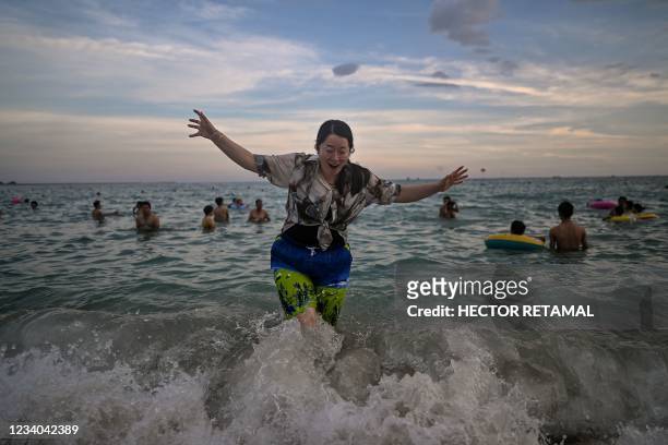 Woman takes a bath at Dadonghai beach in Sanya on China's tropical Hainan Island on July 18, 2021.