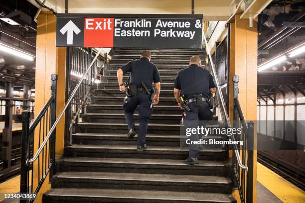 New York Police Department officers patrol in the Franklin Avenue subway station amid a rise of gun violence in the Brooklyn borough of New York,...