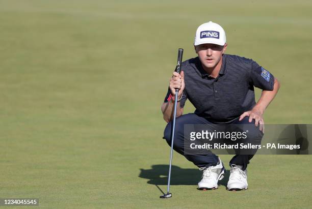 Canada's Mackenzie Hughes lines up a putt during day four of The Open at The Royal St George's Golf Club in Sandwich, Kent. Picture date: Sunday July...