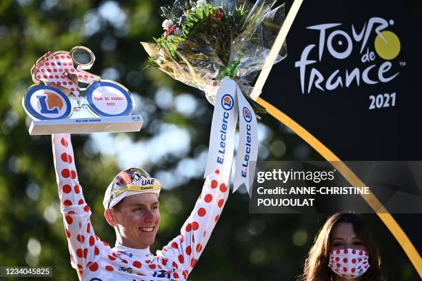 Team UAE Emirates' Tadej Pogacar of Slovenia celebrates his best climber's polka dot jersey on the podium at the end of the 21th and last stage of...