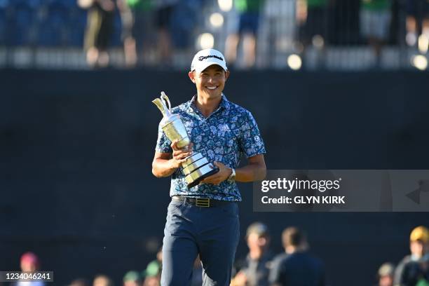 Golfer Collin Morikawa poses for pictures with the Claret Jug, the trophy for the Champion Golfer of the Year, after winning the 149th British Open...