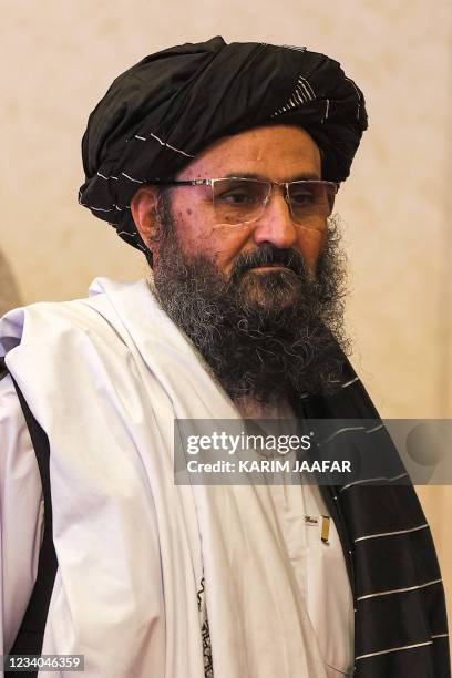 The leader of the Taliban negotiating team Mullah Abdul Ghani Baradar walks after the final declaration of the peace talks between the Afghan...