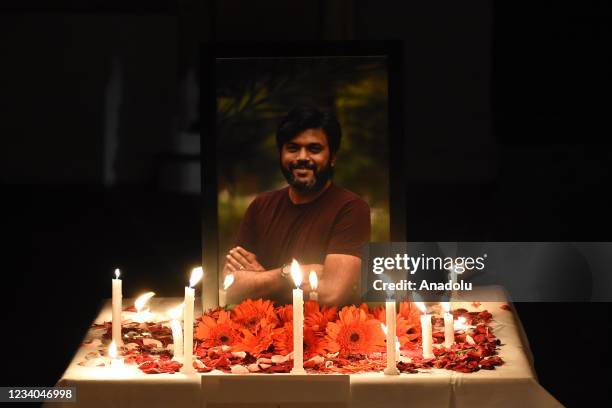 Candles are lit near the portrait of Reuters chief photojournalist in Srinagar,Kashmir on July 18, 2021. The Pulitzer Prize-winning photojournalist...