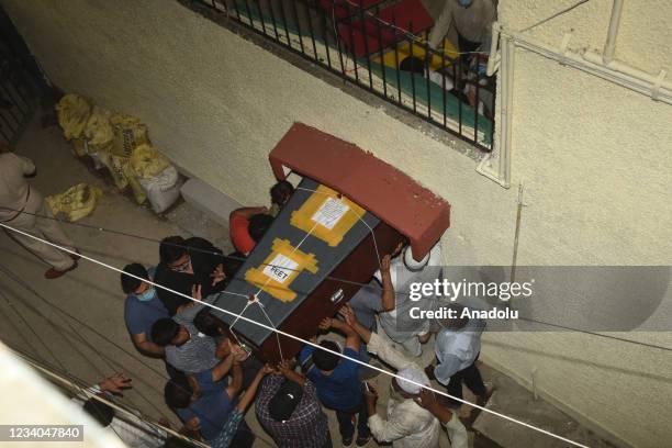 People carry the coffin of Reuters journalist Danish Siddiqui at his residence in New Delhi on July 18 after the Pulitzer Prize-winning photographer...