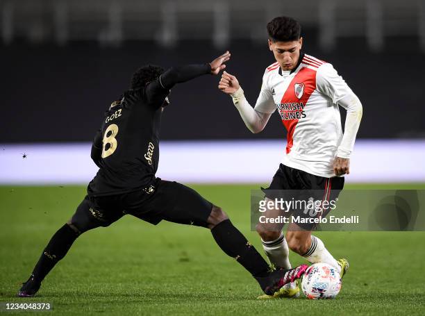 Jorge Carrascal of River Plate fights for the ball with Yeiler Goez of Colon during a match between River Plate and Colon as part of Torneo 2021 of...