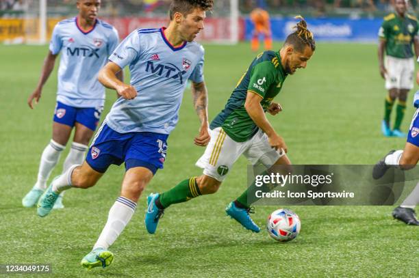 Portland Timbers midfielder Sebastián Blanco dribbles past FC Dallas defender Ryan Hollingshead during an MLS match between the Portland Timbers and...