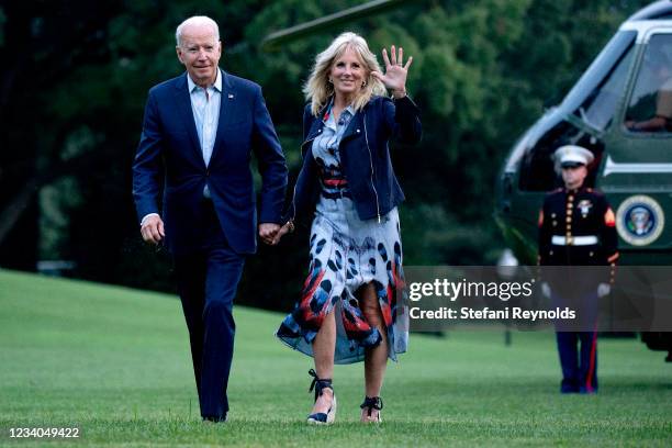 President Joe Biden and first lady Jill Biden walk on the South Lawn of the White House on July 18, 2021 in Washington, DC. The Bidens were returning...