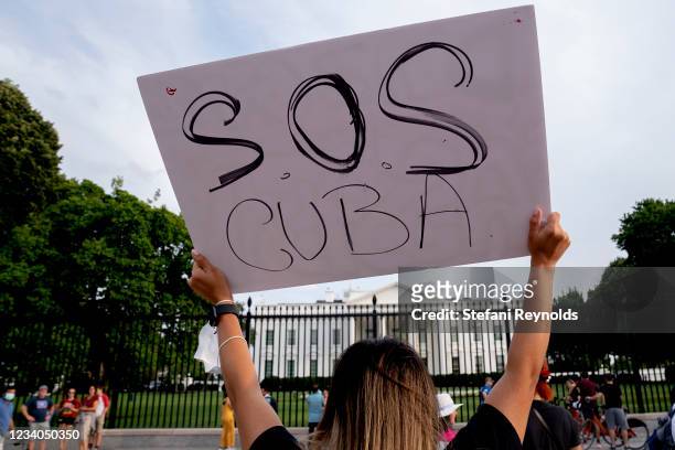 Demonstrator gathers with others in solidarity with protests in Cuba outside the White House on July 18, 2021 in Washington, DC. The protests come...