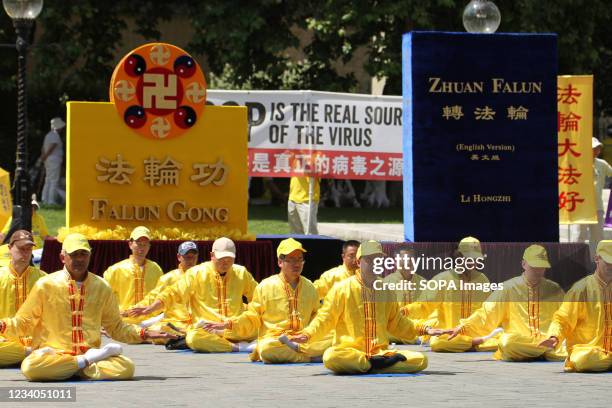 Falun Gong practitioners and supporters meditate outside the Houses of Parliament during a protest against the Chinese government's persecution. The...