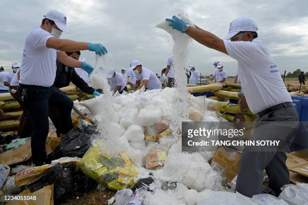 Officials prepare to burn seized illegal drugs to mark the United Nations's special international day to fight drug abuse and illicit trafficking,...