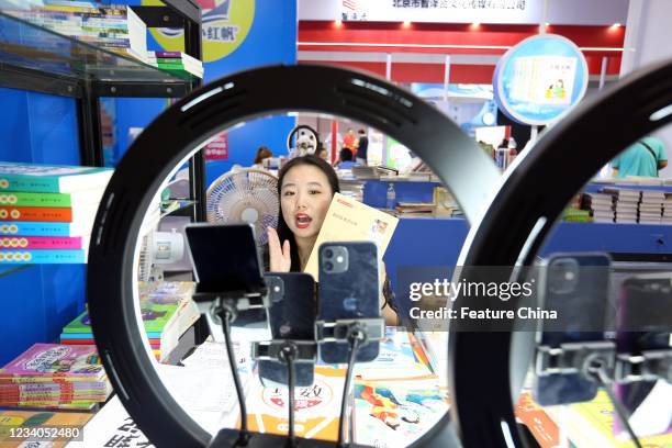 Woman sells books on livestream platforms during a book fair in Jinan city in east China&#039;s Shandong province Saturday, July 17, 2021.