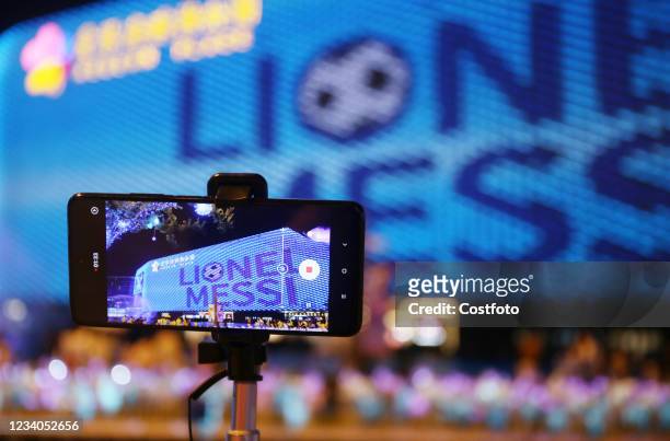 Video of Argentine soccer star Lionel Messi leading the national team to win the Copa America is displayed on the giant screen of the Whale Wall in...
