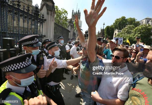 Protesters confront a police line outside the House of Commons during a freedom protest on July 19, 2021 in London, England. Anti-lockdown protests...