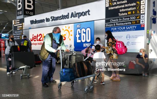 Passengers pass through the check-in area at London Stansted Airport, operated by Manchester Airport Plc, in Stansted, U.K., on Monday, July 19,...