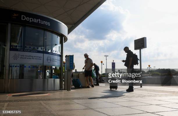 Passengers enter the departures area at London Stansted Airport, operated by Manchester Airport Plc, in Stansted, U.K., on Monday, July 19, 2021....