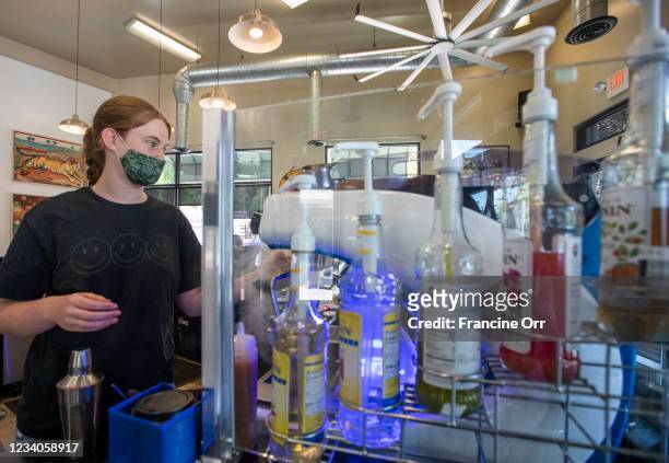 Barista Ava Dorny is wearing a face mask as she works at Charlie's Coffee House during the coronavirus pandemic on Sunday, July 18, 2021 in South...