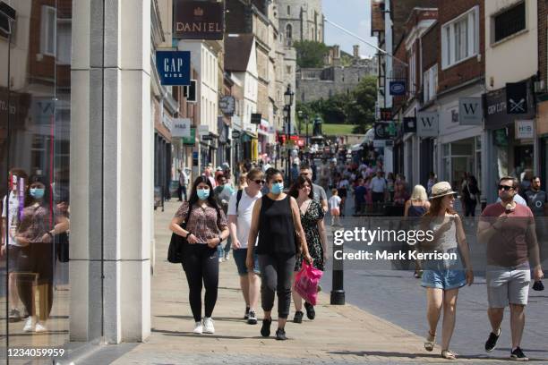 Shoppers and visitors, some of whom wearing face coverings, are pictured close to Windsor Castle on 'Freedom Day', when the UK government lifted...