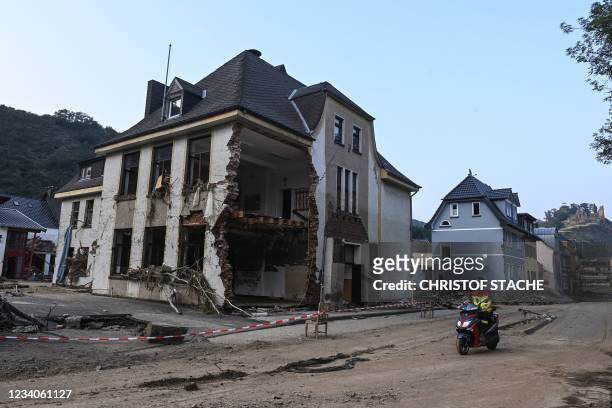 Man drives past a demolished house in Altenahr, Rhineland-Palatinate, western Germany, on July 19 after devastating floods hit the region. - The...