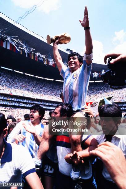 Diego Maradona of Argentina is lifted by his team mates and staffs after winning the FIFA World Cup Mexico final between Argentina and West Germany...