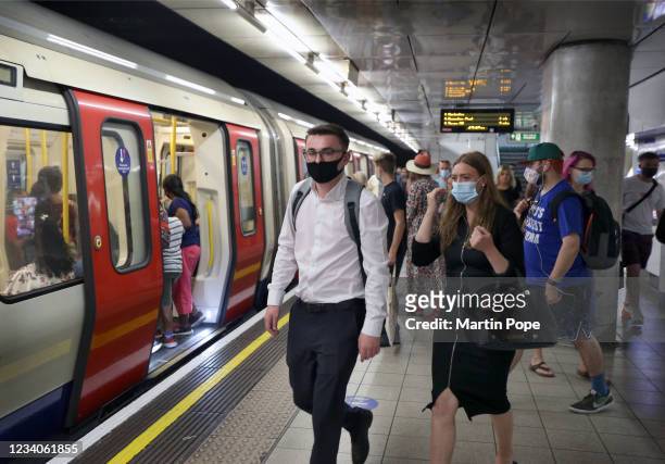 Passengers on a busy platform at the Embankment all choose to wear a face covering as they start their journey home on July 19, 2021 in London,...