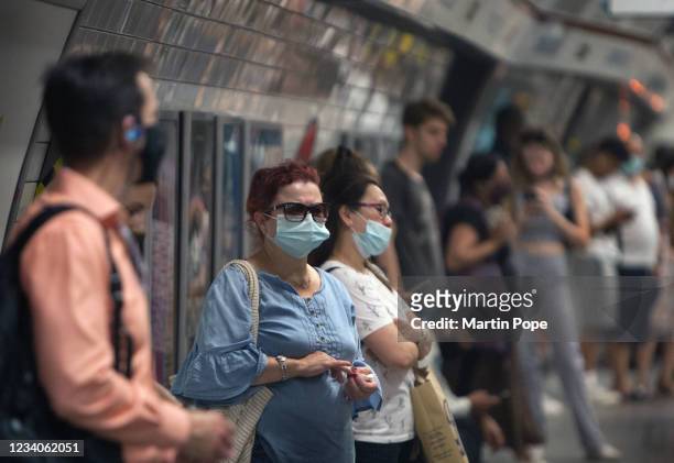 Commuters using the Bakerloo line at Oxford Circus mostly opt to wear face coverings on July 19, 2021 in London, United Kingdom. As of 12:01 on...