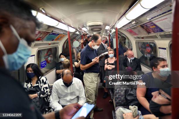 Passengers on a busy Bakerloo line train going north at rush hour with most commuters wearing face coverings on July 19, 2021 in London, United...