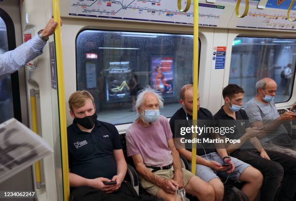 Passengers on a District Line train heading east mostly opt for face coverings on July 19, 2021 in London, United Kingdom. As of 12:01 on Monday,...