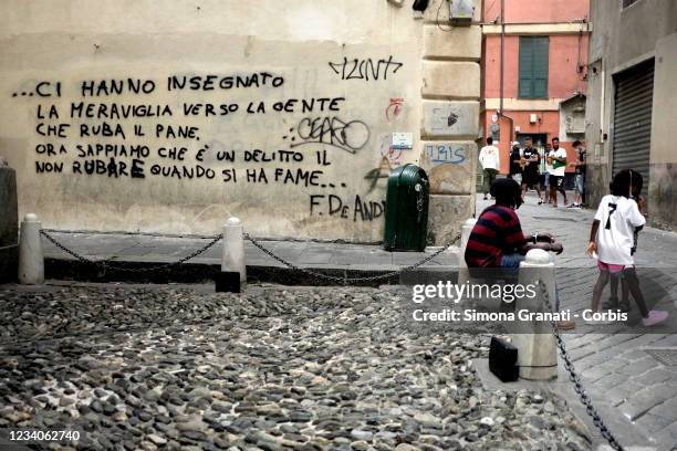 People in Via del Campo in front of the words of the song by the Genoese singer-songwriter Fabrizio de André "nella mia ora di libertà, on July 19,...