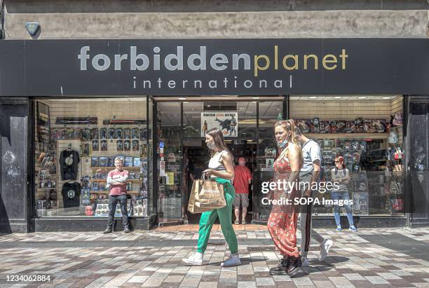 Shoppers walk by Forbidden Planet Comic Book Shop on Ann Street.