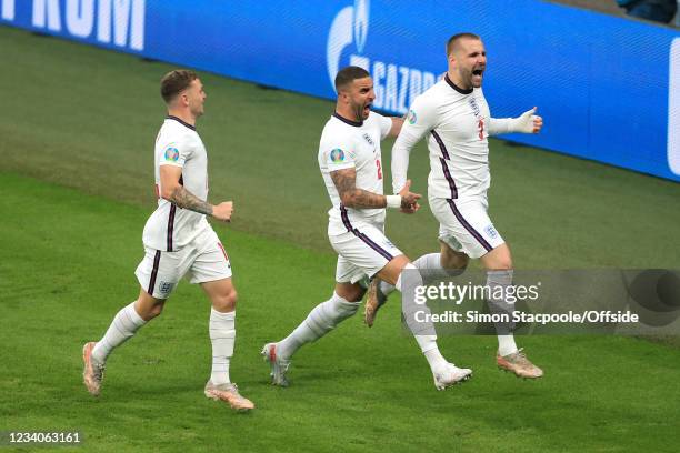 Luke Shaw of England celebrates with Kyle Walker of England and Kieran Trippier of England after scoring their 1st goal during the UEFA Euro 2020...