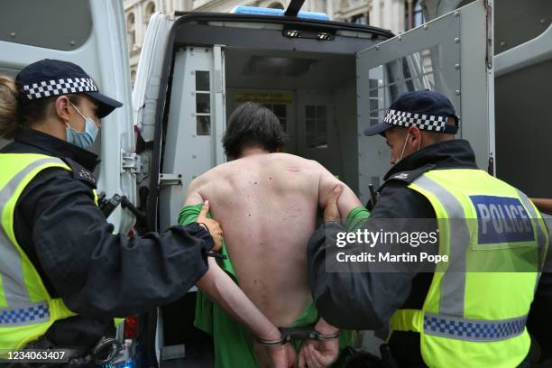 Protester is arrested for blocking the highway in Whitehall as part of a freedom demonstration on July 19, 2021 in London, England. Anti-lockdown...