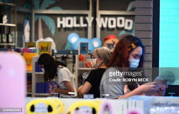 People shop at a store in Hollywood, California, on July 19 the second day of the return of the indoor mask mandate in Los Angeles County due to a...