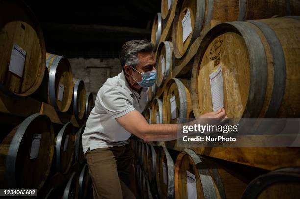 Jean-Olivier Petrich, co-owner of The Domaine de La Flaguerie / Les Vergers de Ducy, checks the old oak barrels used to age Calvados . On Monday,...