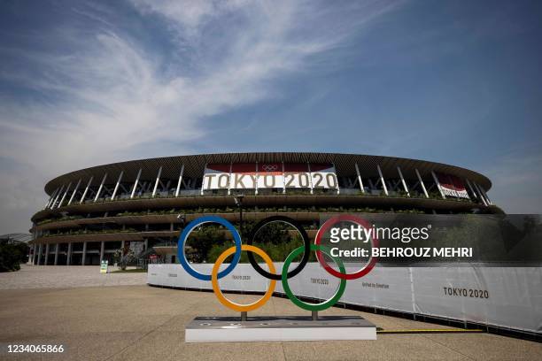 This picture shows the Olympic rings and Olympic Stadium in Tokyo on July 20 ahead of the Tokyo 2020 Olympic Games.