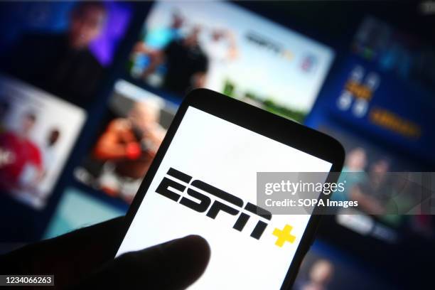 In this photo illustration the ESPN+ logo of an US video streaming service is seen on a smartphone with its website in the background.