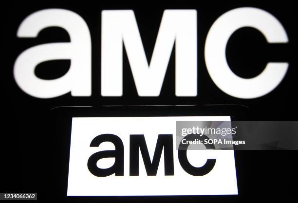 In this photo illustration an AMC logo of an US cable television channel is seen on a smartphone and a pc screen.