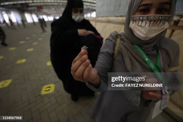 Muslim worshippers cast stones as part of a symbolic stoning of the devil ritual, during the Hajj pilgrimage in Mina, near Saudi Arabia's holy city...