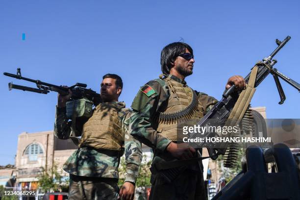 Afghan security personnel are on alert outside the blue mosque during the Eid al-Adha prayers in Herat on July 20, 2021.