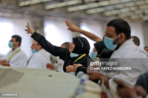 Muslim worshippers cast pebbles during a symbolic stoning of the devil ritual, as part of the Hajj pilgrimage in Mina, near Saudi Arabia's holy city...