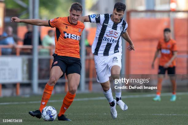 Sinan Bakis of Heracles Almelo battle for the ball during the Pre-Season Friendly match between FC Volendam and Heracles Almelo at Kras Stadion on...
