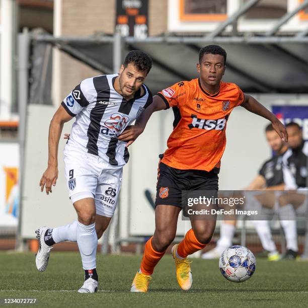 Sinan Bakis of Heracles Almelo and Brian Plat of Volendam battle for the ball during the Pre-Season Friendly match between FC Volendam and Heracles...