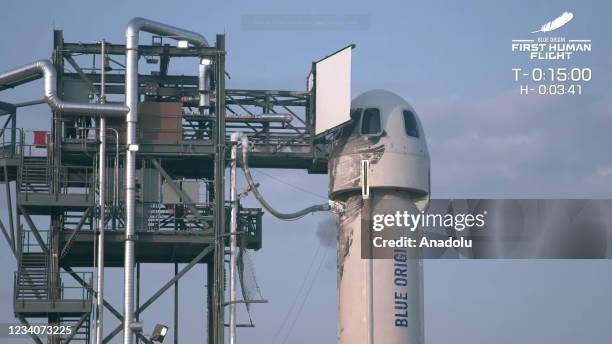 The New Shepard Blue Origin rocket prepares to lift-off from the launch pad carrying Jeff Bezos along with his brother Mark Bezos, 18-year-old Oliver...