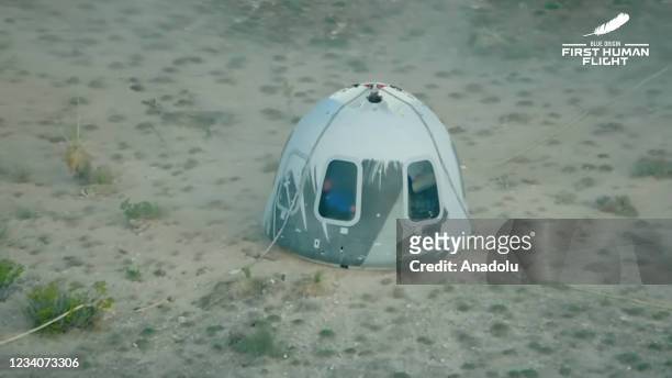 Blue Originâs New Shepard crew capsule lands on the end of its parachute system carrying Jeff Bezos along with his brother Mark Bezos, 18-year-old...