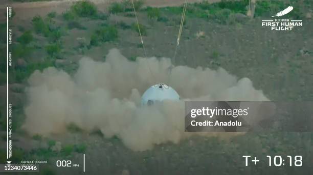 Blue Originâs New Shepard crew capsule lands on the end of its parachute system carrying Jeff Bezos along with his brother Mark Bezos, 18-year-old...